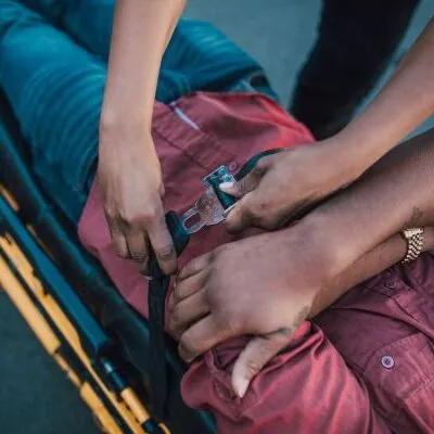 injured victim being secured to stretcher
