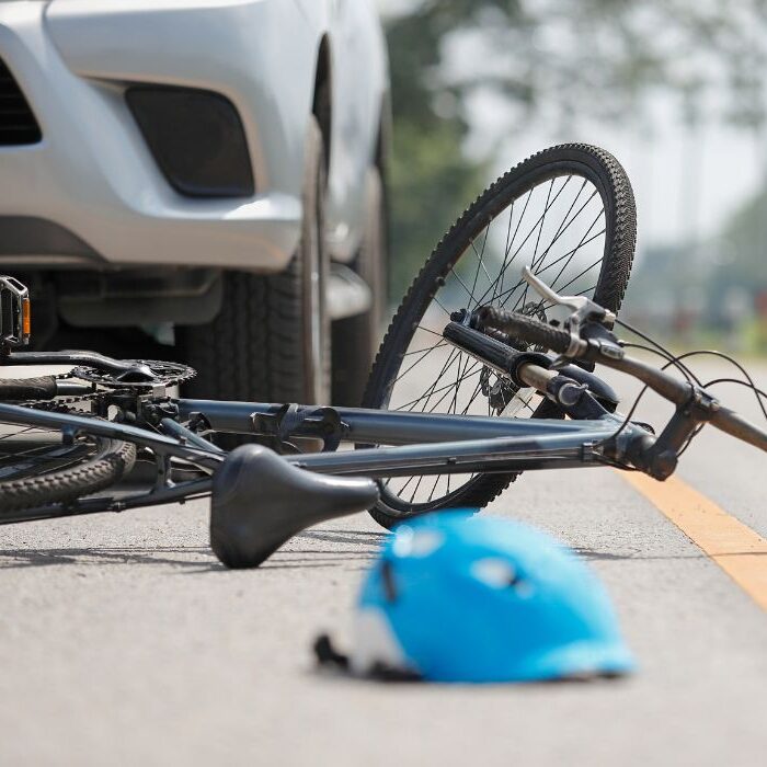 bicycle and helmet on asphalt after being run over