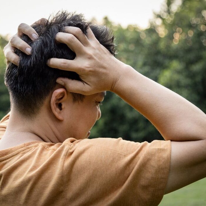 man holding head to signify brain injury